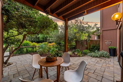 a view of a backyard with sitting area