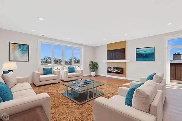 a living room with furniture fireplace and a window