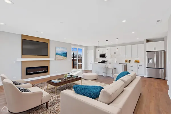 a living room with furniture a fireplace and a flat screen tv