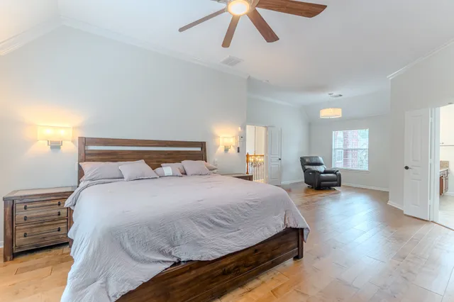 a spacious bedroom with a bed and cabinet