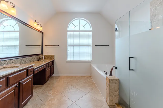 a large bathroom with a granite countertop sink and a mirror