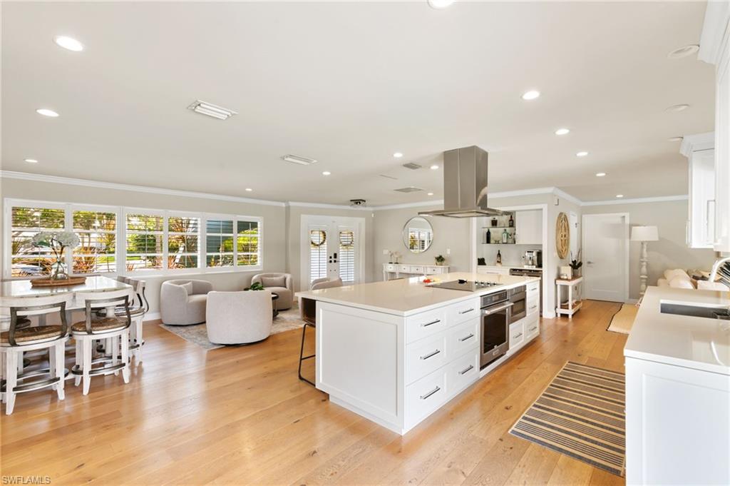 2140 Shad Court Naples, FL 34102 - Photo 24 of 44 a large kitchen with kitchen island a large island in it