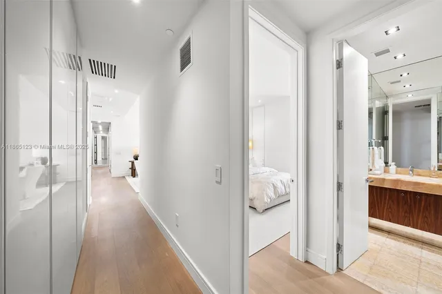 a large bedroom with a large bed and flat screen tv