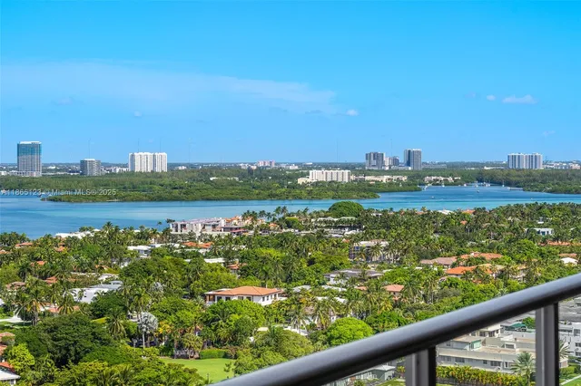 a living room with furniture and large windows