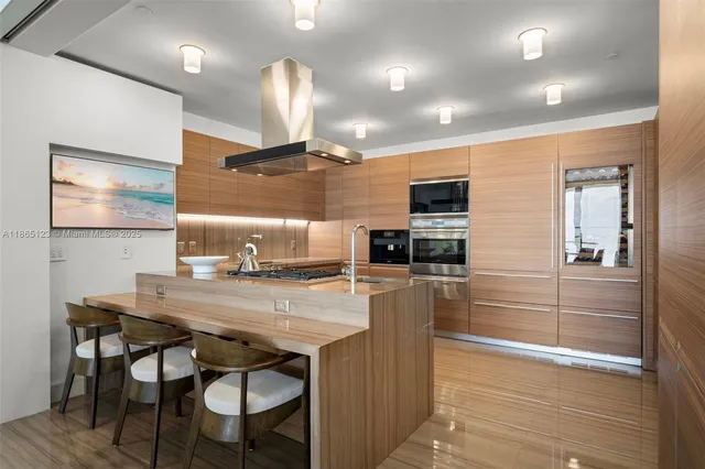 a kitchen with a table chairs refrigerator and microwave
