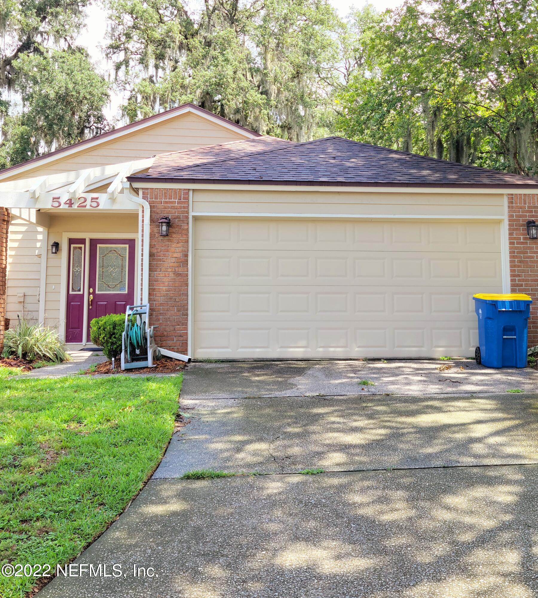 5425 Spring Brook Road Jacksonville, FL 32277 - Photo 1 of 35 a front view of a house with garden