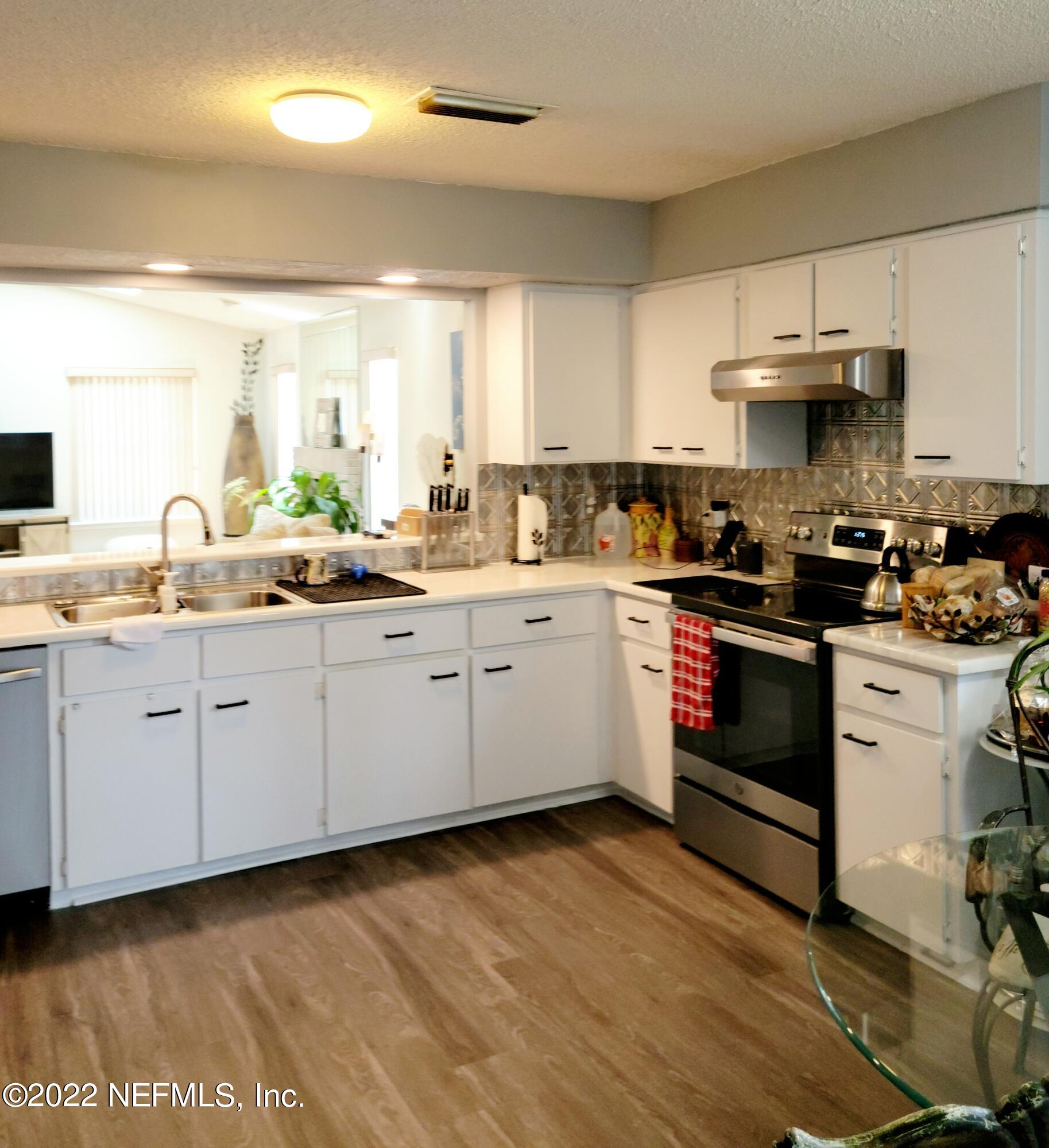 5425 Spring Brook Road Jacksonville, FL 32277 - Photo 12 of 35 a kitchen with a sink a stove and cabinets