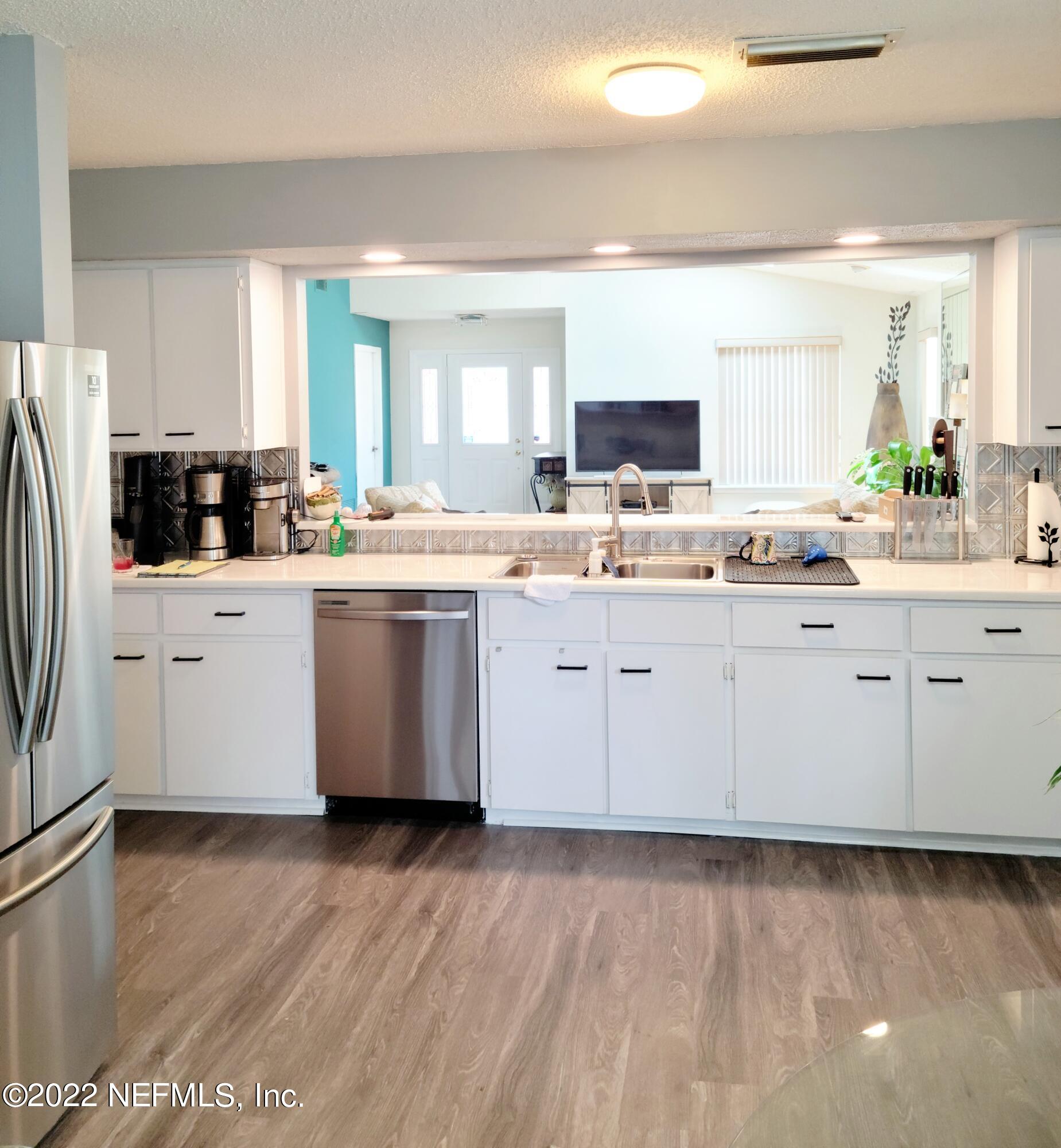 5425 Spring Brook Road Jacksonville, FL 32277 - Photo 13 of 35 a kitchen with stainless steel appliances a sink and a refrigerator