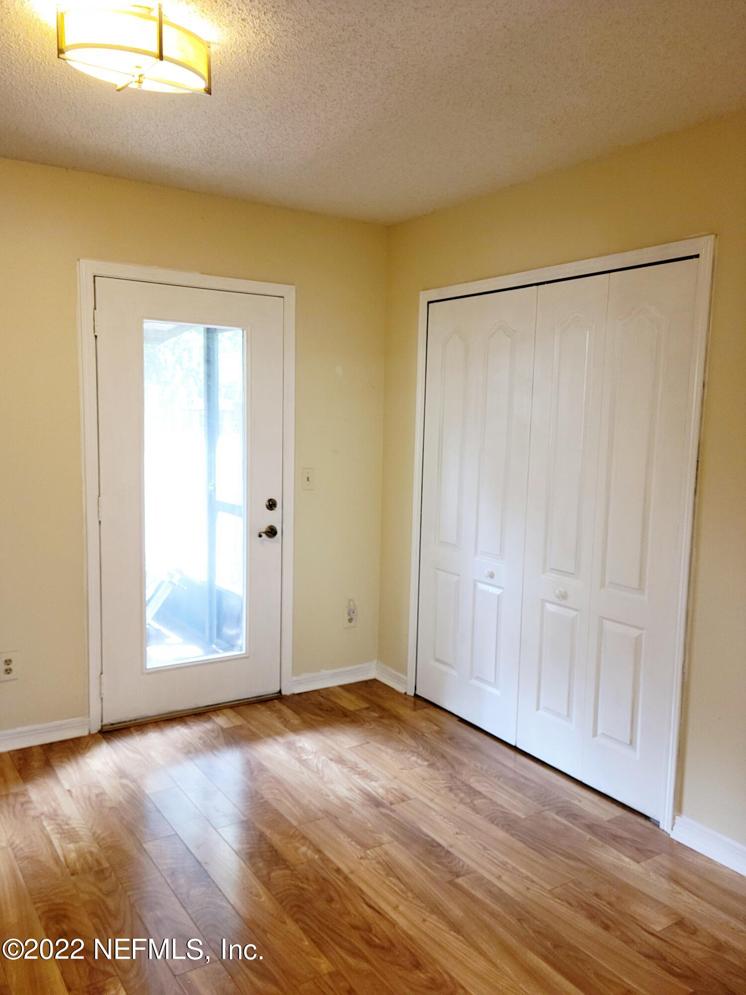 5425 Spring Brook Road Jacksonville, FL 32277 - Photo 18 of 35 an empty room with wooden floor closet and windows