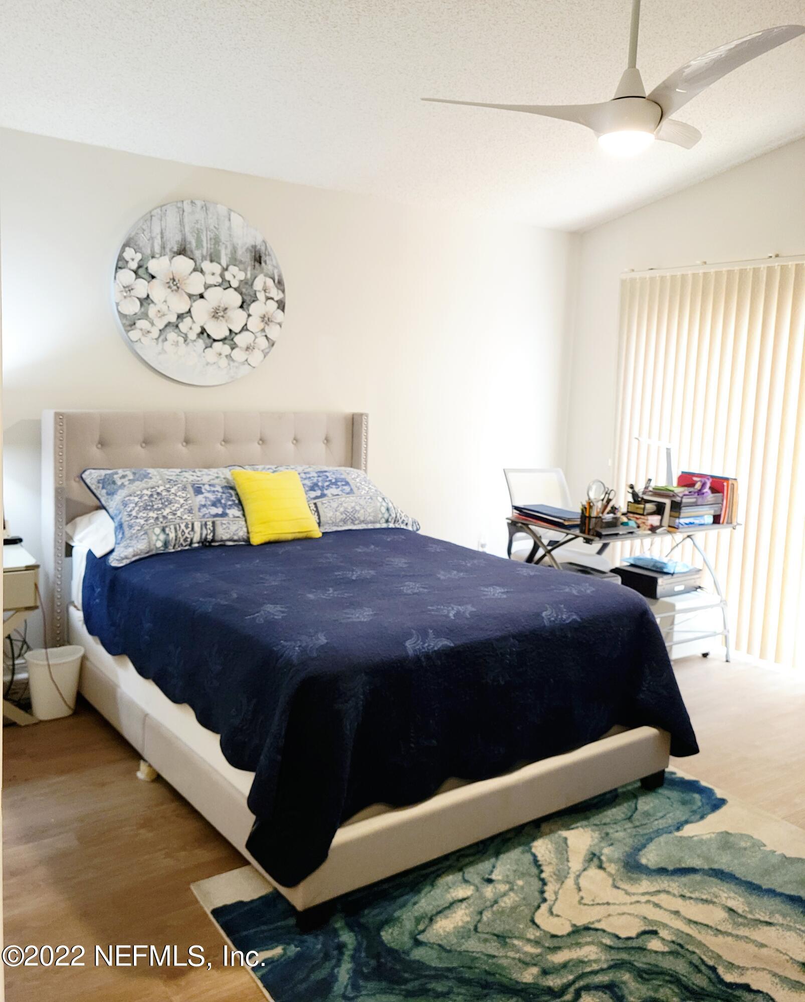 5425 Spring Brook Road Jacksonville, FL 32277 - Photo 20 of 35 a bedroom with a bed lamp and a window
