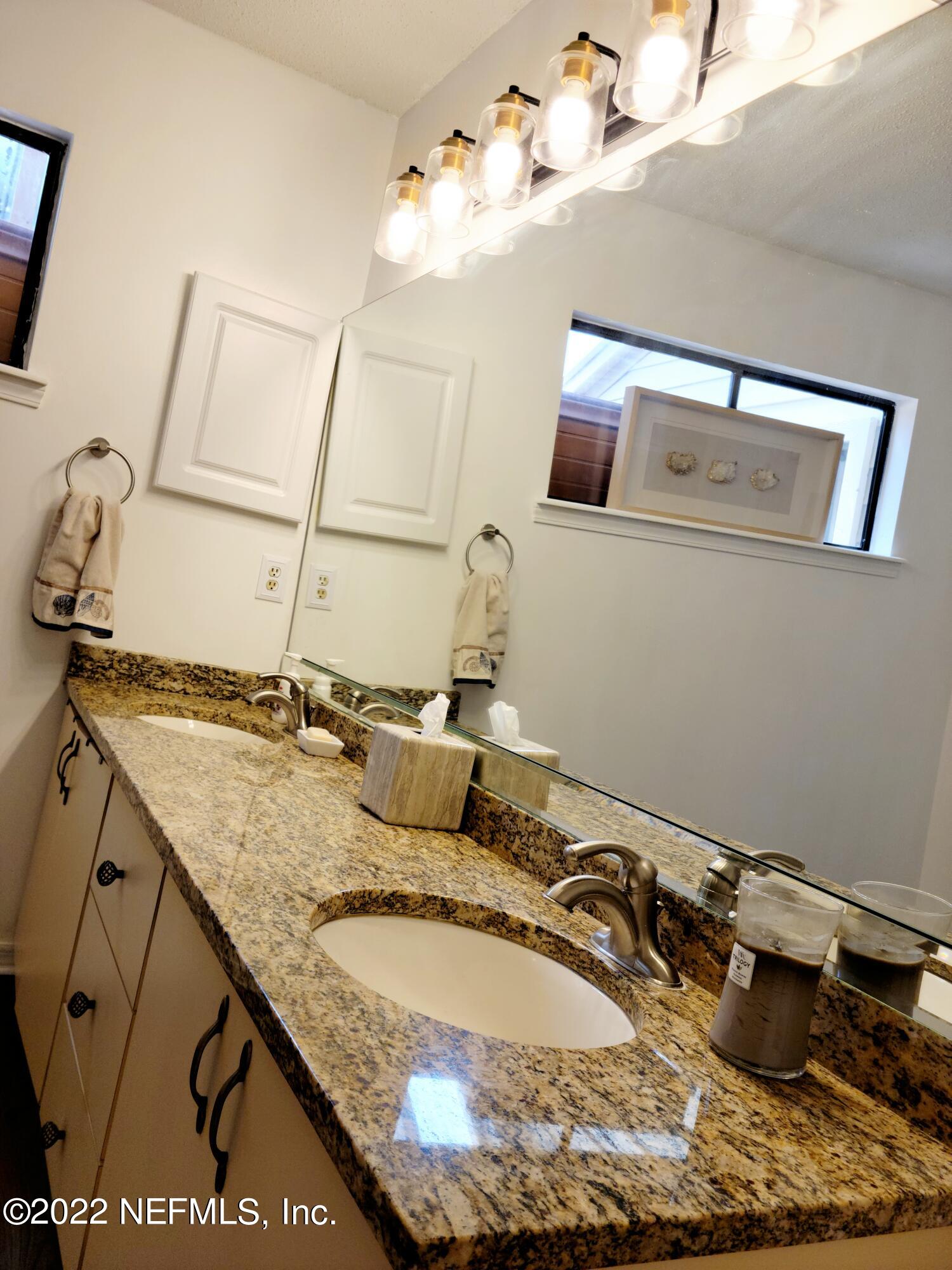 5425 Spring Brook Road Jacksonville, FL 32277 - Photo 24 of 35 a bathroom with a granite countertop sink and a mirror