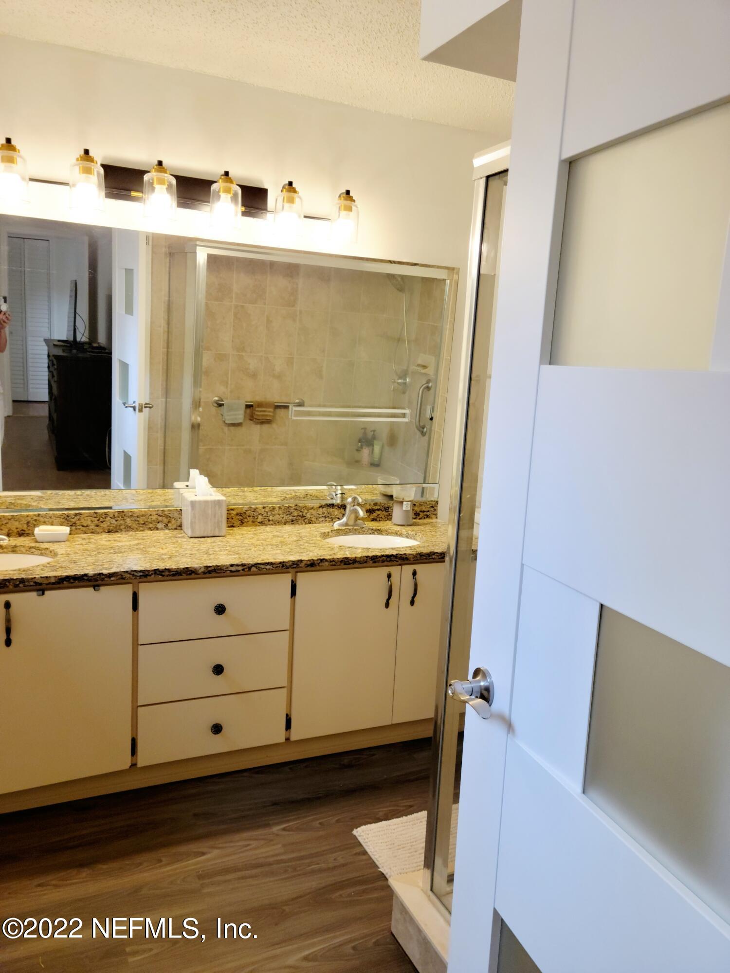 5425 Spring Brook Road Jacksonville, FL 32277 - Photo 26 of 35 a bathroom with a granite countertop sink and a mirror