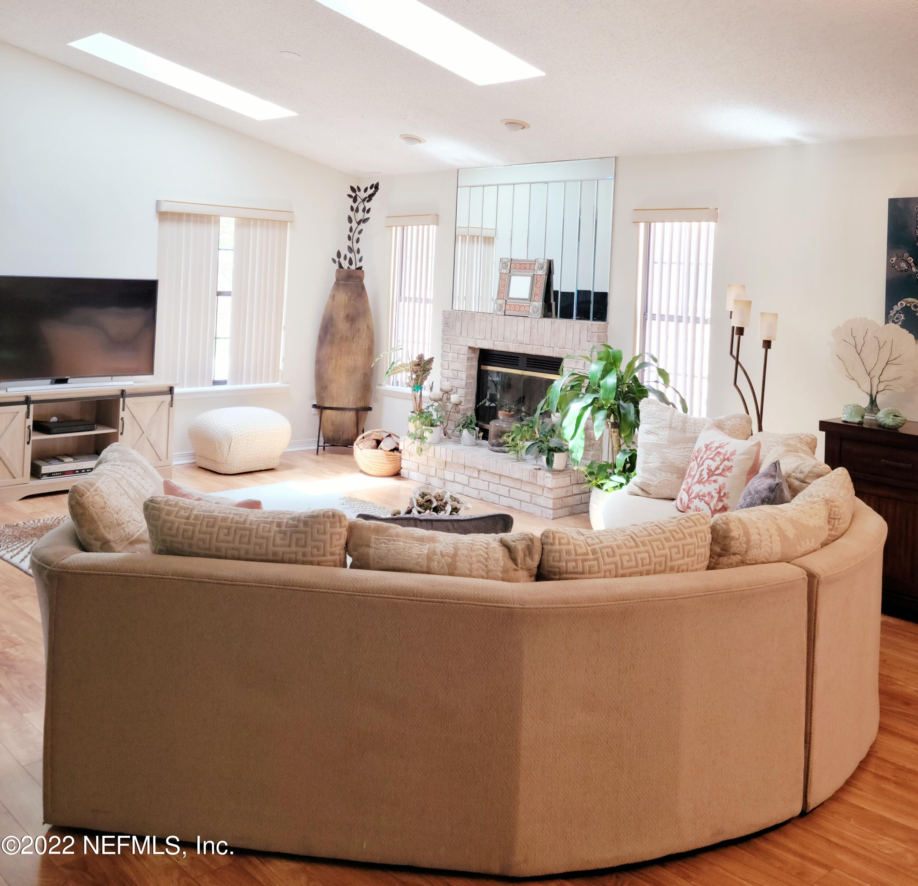 5425 Spring Brook Road Jacksonville, FL 32277 - Photo 8 of 35 a living room with furniture and a flat screen tv