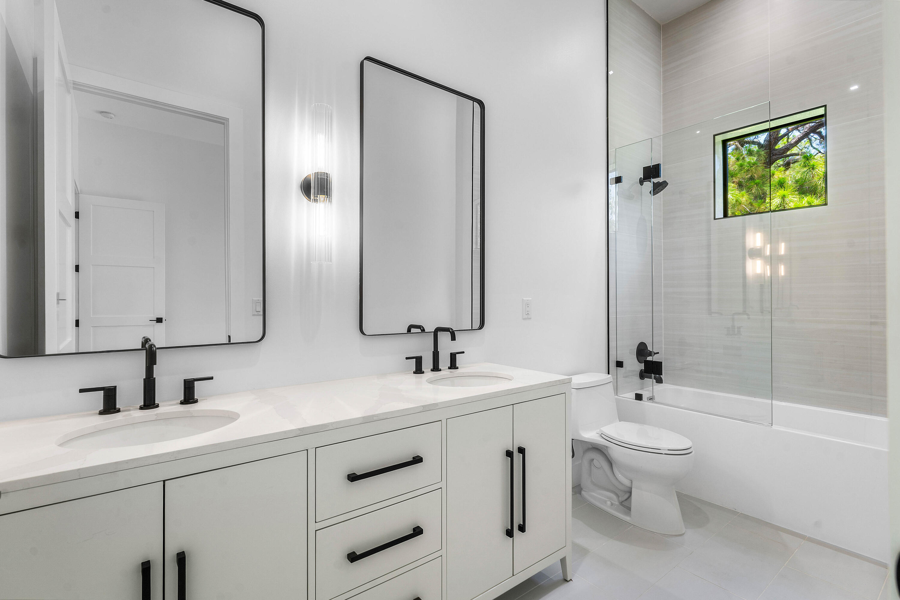 5701 Old Orange Road Jupiter, FL 33458 - Photo 30 of 46 a bathroom with a double vanity sink toilet and shower