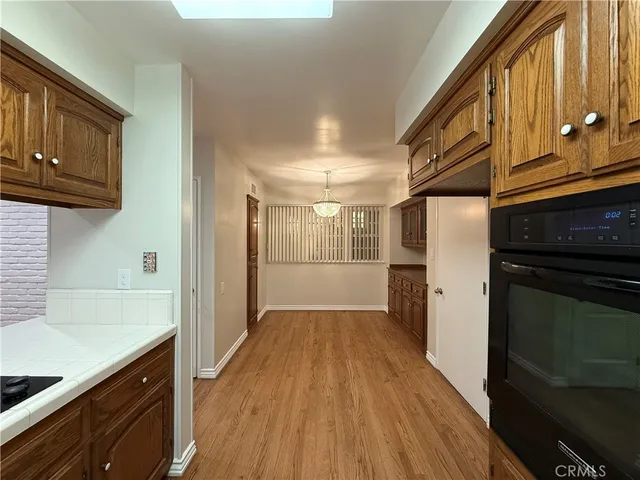 a kitchen with granite countertop wooden cabinets and stainless steel appliances