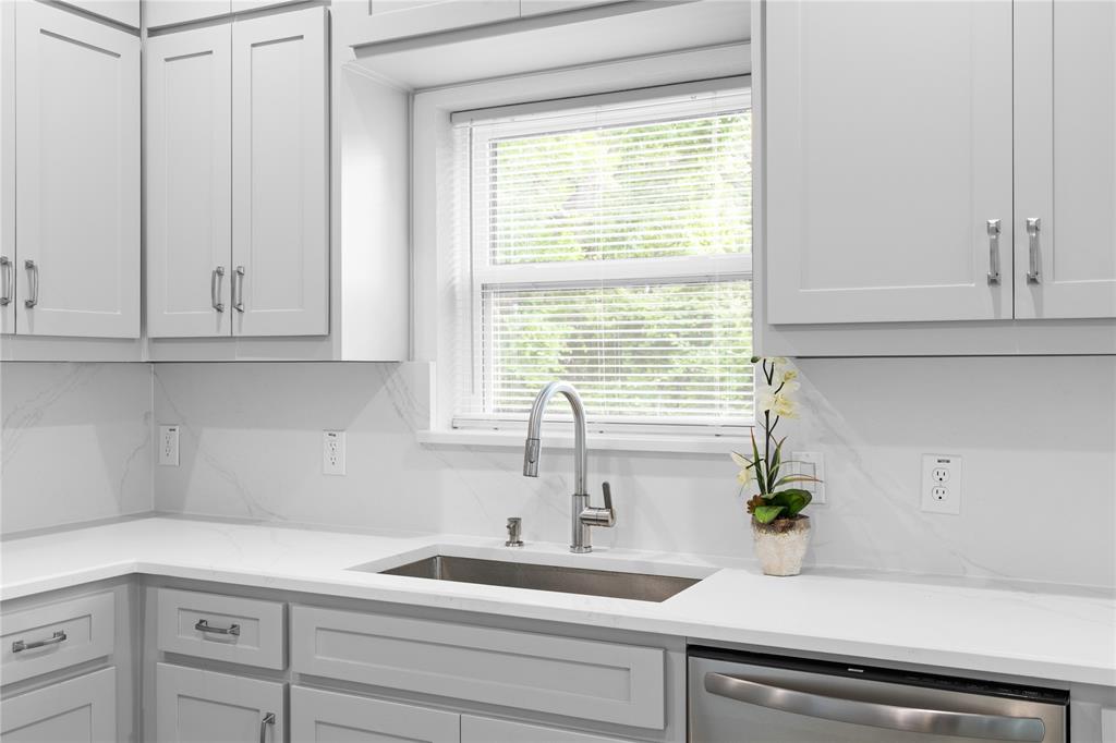 709 South Church Street Decatur, TX 76234 - Photo 11 of 14 a kitchen with stainless steel appliances white cabinets and a window