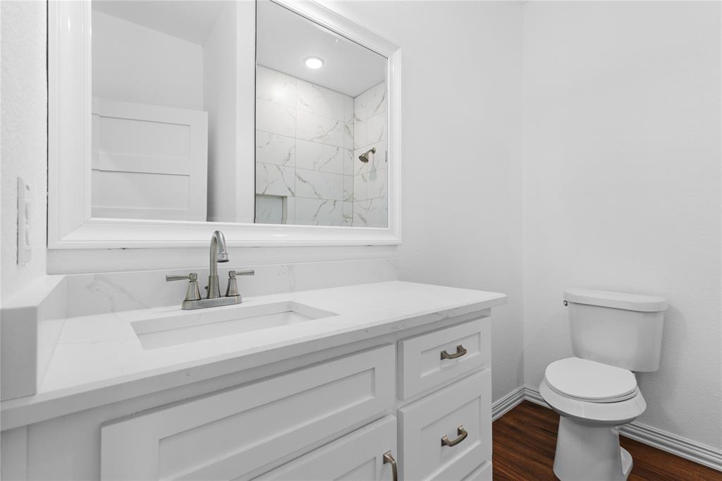 709 South Church Street Decatur, TX 76234 - Photo 12 of 14 a bathroom with a sink toilet and mirror