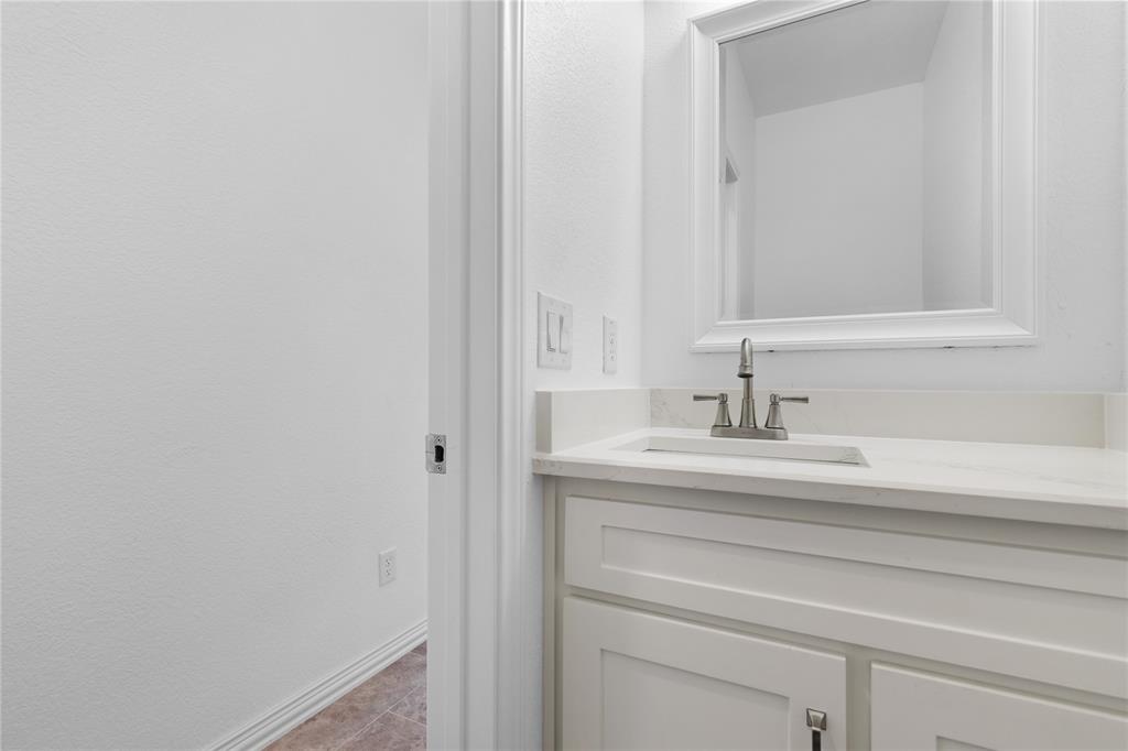 709 South Church Street Decatur, TX 76234 - Photo 13 of 14 a bathroom with a sink and a mirror