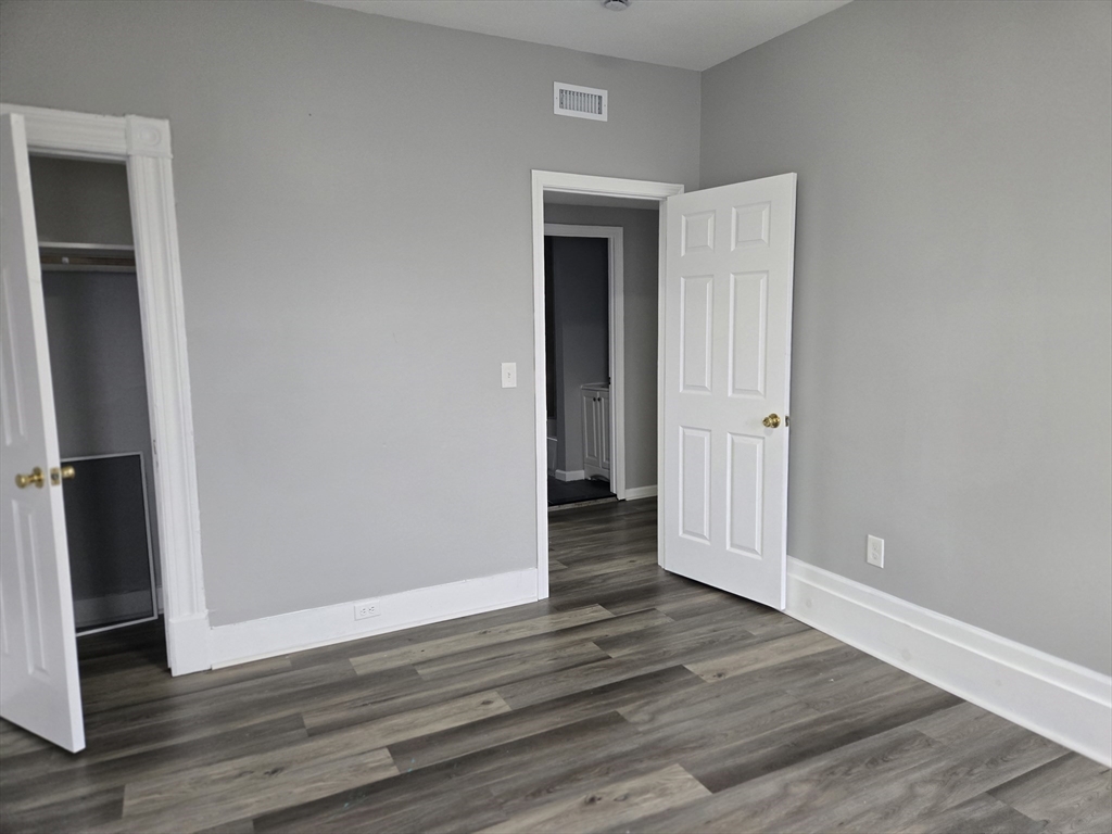 123 Walnut Street, Unit 4L Holyoke, MA 01040 - Photo 15 of 16 a view of a hallway with wooden floor