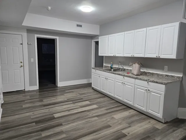 a kitchen with stainless steel appliances granite countertop a sink stove and cabinets
