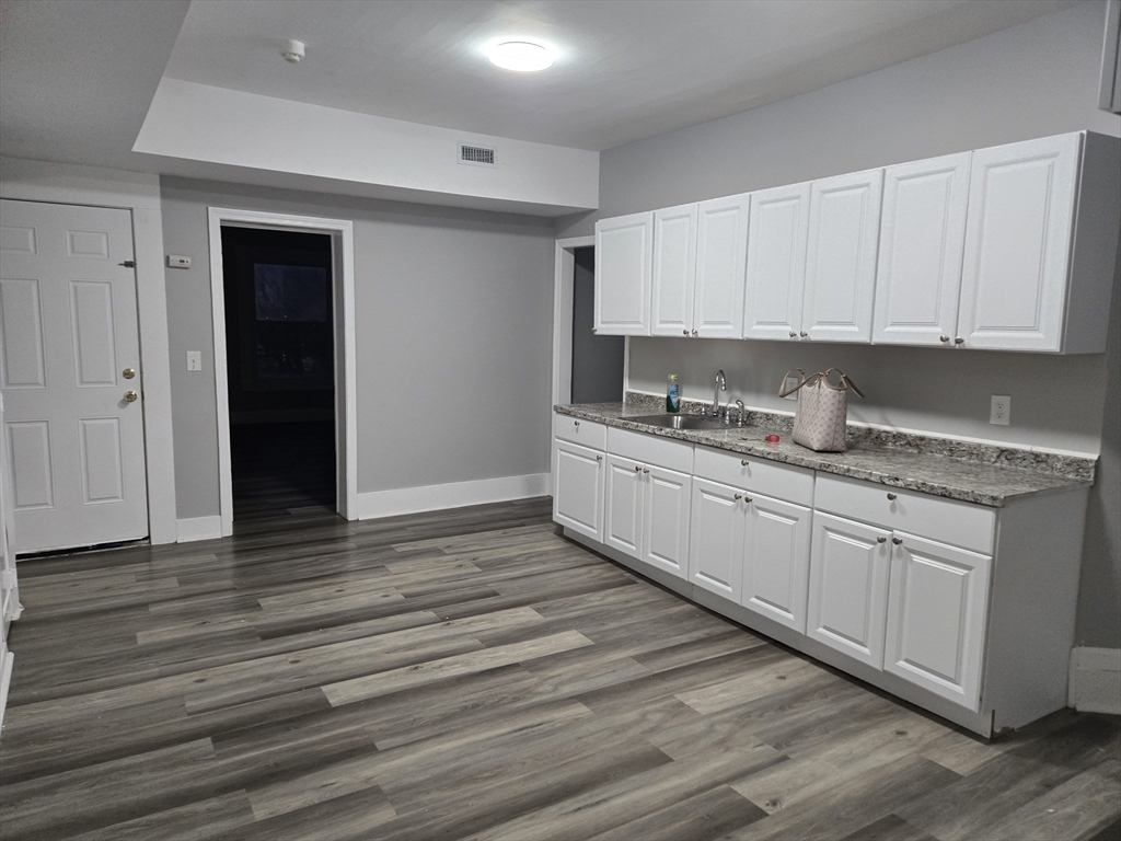 123 Walnut Street, Unit 4L Holyoke, MA 01040 - Photo 2 of 16 a kitchen with stainless steel appliances granite countertop a sink stove and cabinets