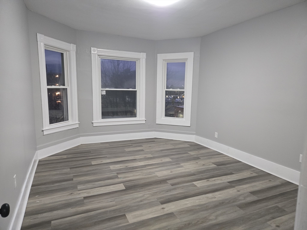 123 Walnut Street, Unit 4L Holyoke, MA 01040 - Photo 3 of 16 a view of an empty room with wooden floor and window