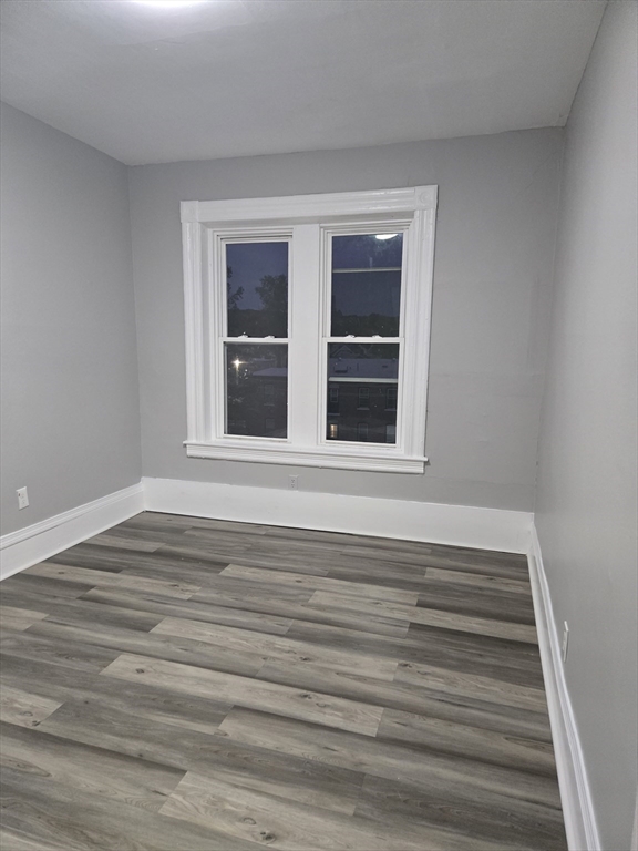 123 Walnut Street, Unit 4L Holyoke, MA 01040 - Photo 9 of 16 a view of an empty room with wooden floor and windows