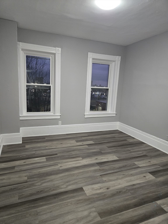 123 Walnut Street, Unit 4L Holyoke, MA 01040 - Photo 10 of 16 a view of an empty room with wooden floor and a window