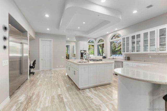a kitchen with a refrigerator and a sink