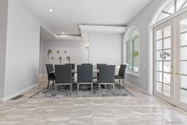 a view of a kitchen with kitchen island a sink a counter top space and living room view