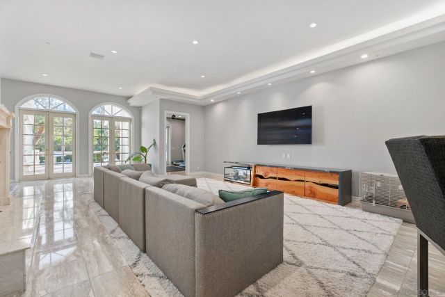 a view of a livingroom with workspace and a window