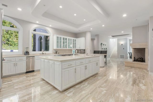 a kitchen with cabinets a sink and appliances
