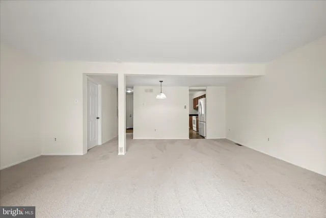 an empty room with an empty space and windows