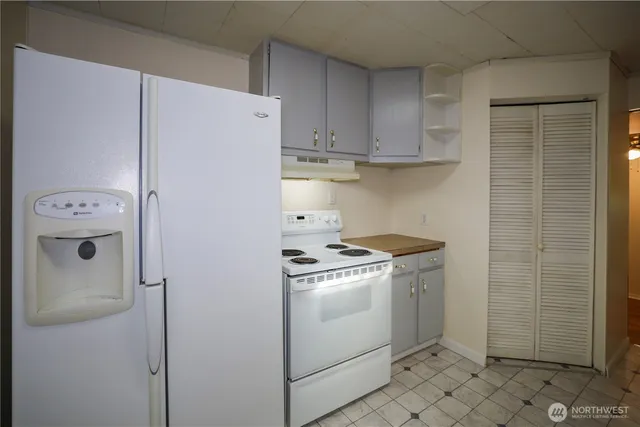 a kitchen with a stove and a refrigerator