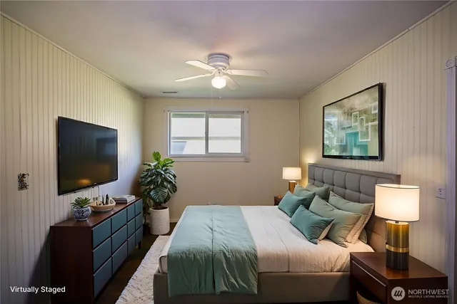 a bedroom with a bed and a flat screen tv