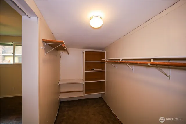 a view of walk in closet with empty racks