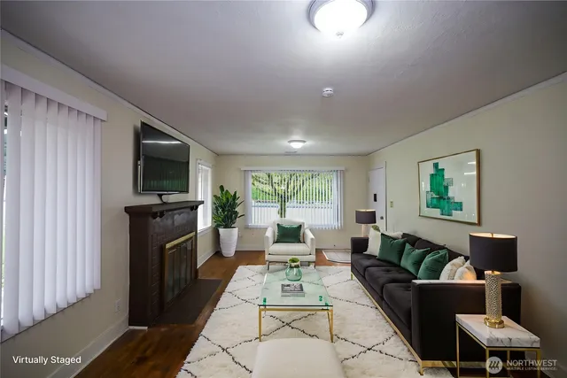 a living room with furniture a flat screen tv and a fireplace