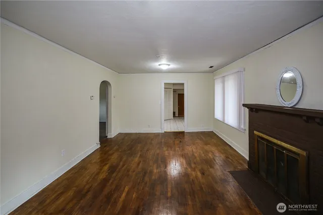 a view of an empty room and wooden floor