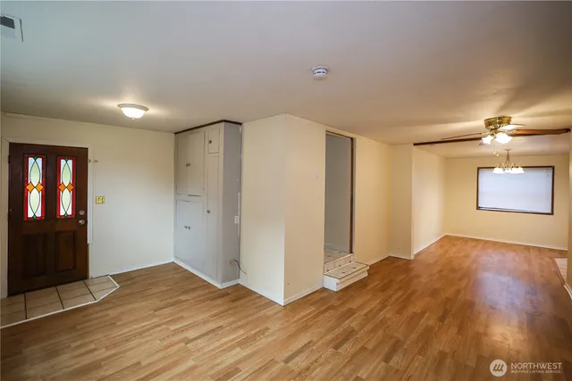 a view of empty room with wooden floor