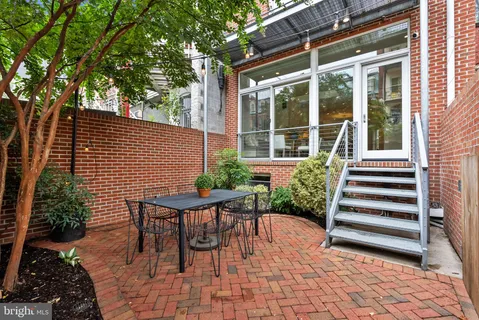 a bathroom with a granite countertop sink a mirror and vanity
