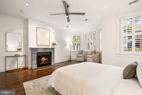 a bedroom with a large bed and a fireplace