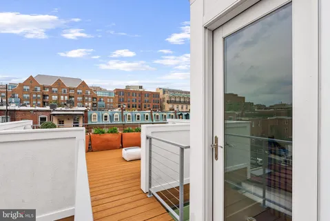 a view of a terrace with couches and city view