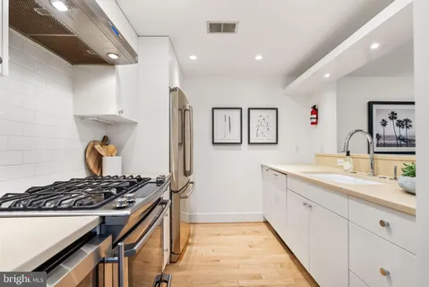 a kitchen with stainless steel appliances a stove and a refrigerator