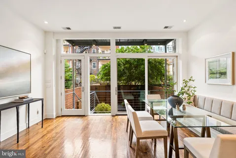 a backyard of a house with barbeque oven table and chairs