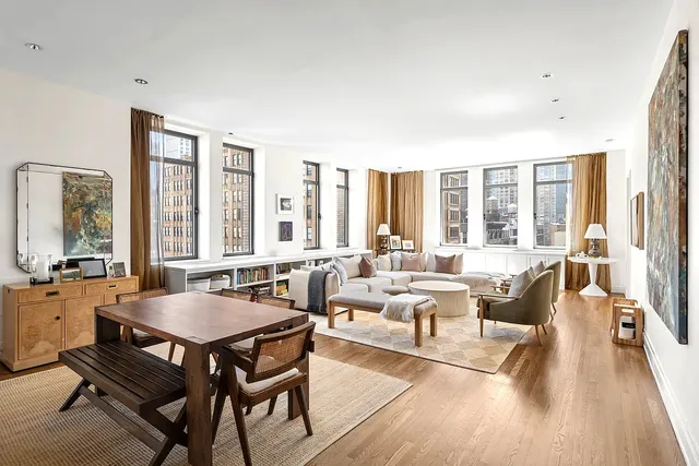 a view of a hallway with chairs and wooden floor
