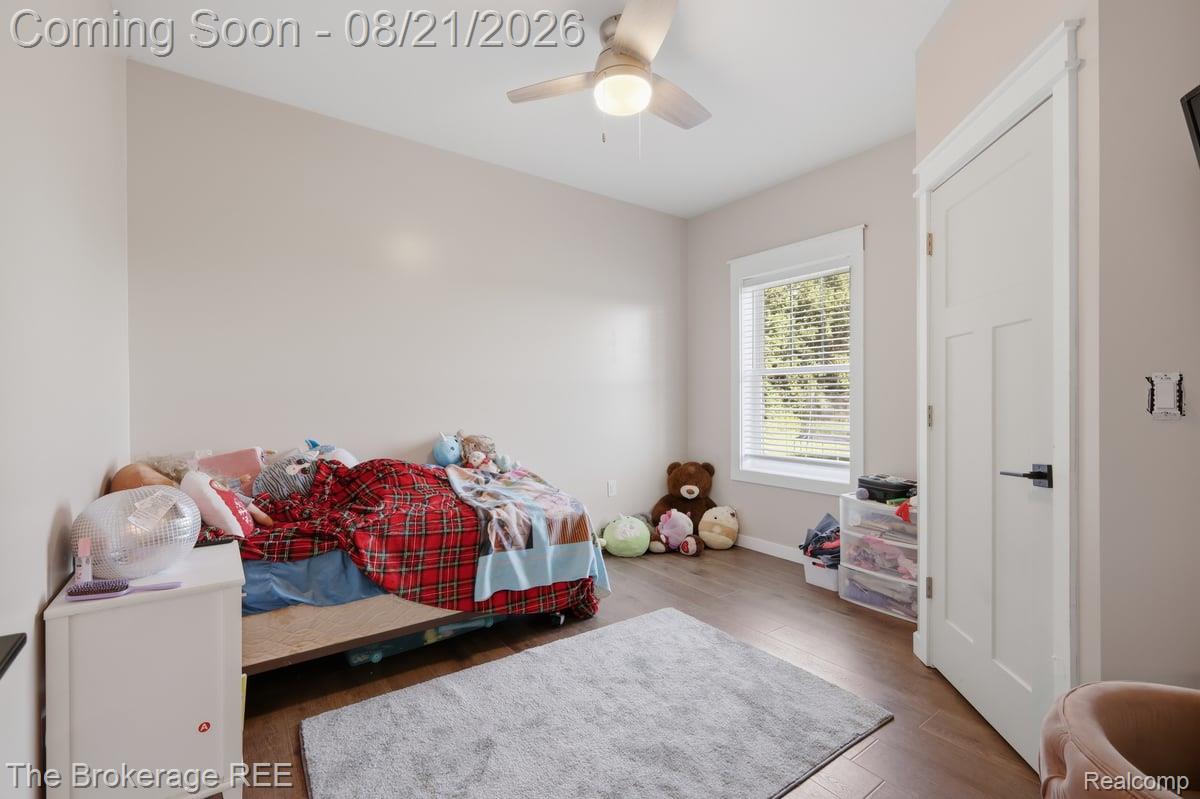 9161 East Coldwater Road Davison, MI 48423 - Photo 34 of 52 Wood-finish flooring, white trim, and a ceiling fan with integrated lighting