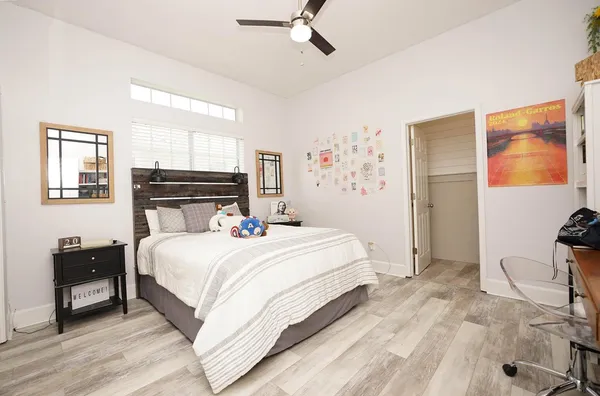 a bedroom with a bed and wooden floor