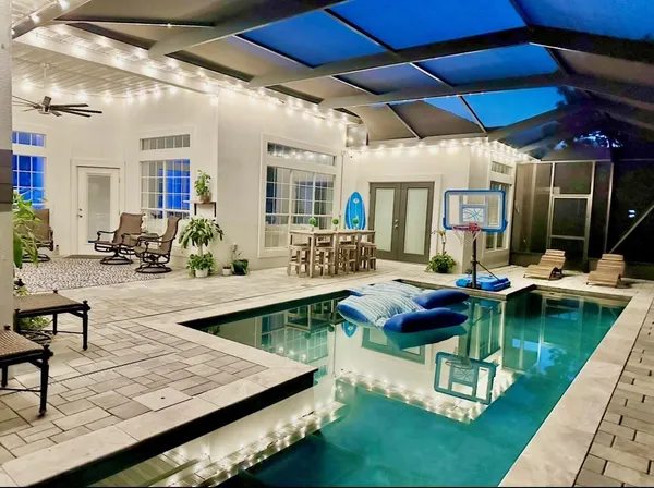 a view of a swimming pool with outdoor seating