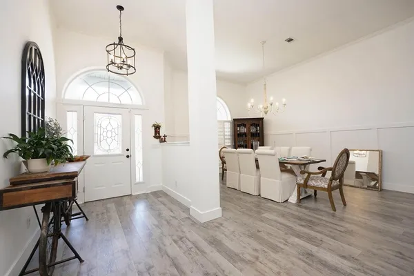 a view of a dining room with furniture and wooden floor