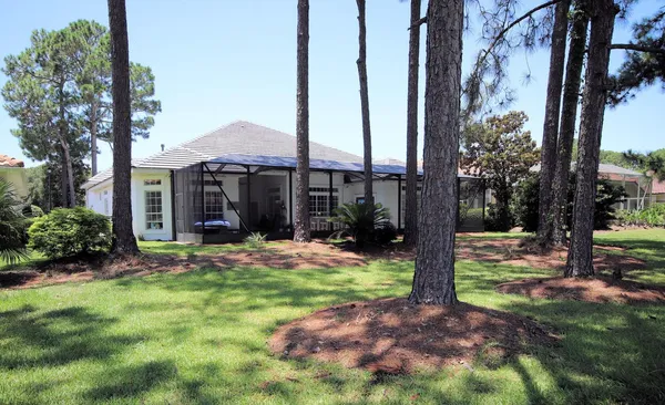 a view of a house with backyard porch and sitting area